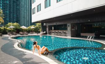 Outdoor swimming pool at Avani Ratchada Bangkok, open-air and well maintained
