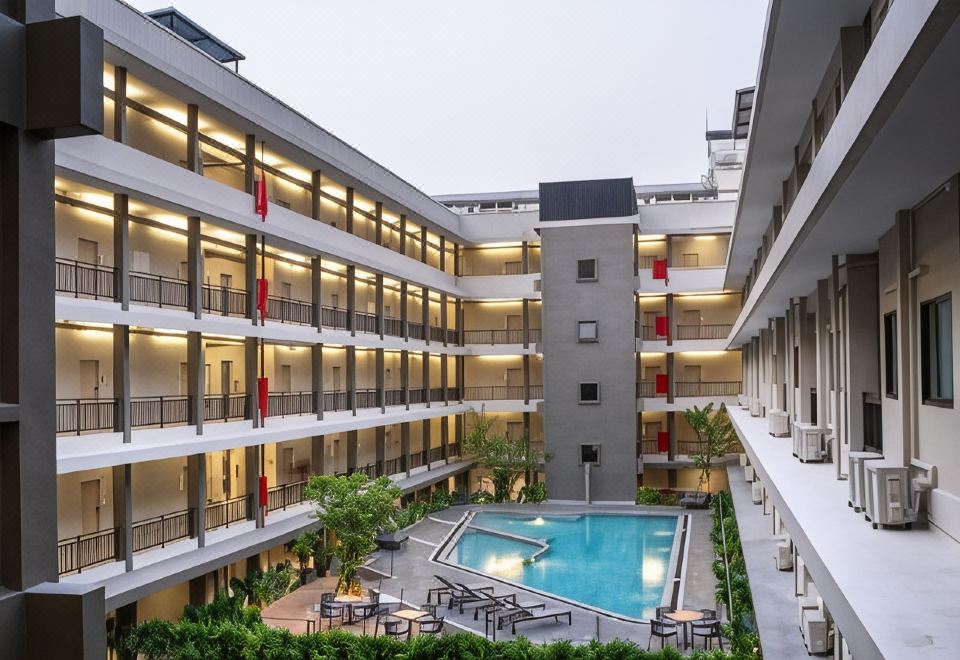 Outdoor saltwater swimming pool at College Haus Rangnam surrounded by tropical greenery
