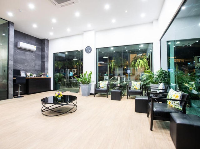 The garden and shared lounge area at Cubic Bangna — a quiet retreat in the Bang Na district