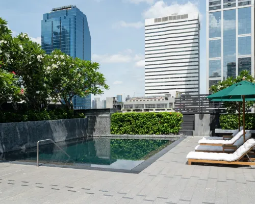 Rooftop saltwater pool at Maitria Hotel Sukhumvit 18 Bangkok with panoramic Bangkok skyline views