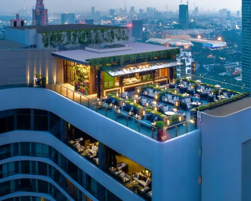 Outdoor pool on the 9th floor of Bangkok Marriott Marquis Queen's Park with views towards Benchasiri Park and the Bangkok skyline