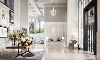 Junior Suite at Oriental Residence Bangkok, warm cream-and-gold tones with city view