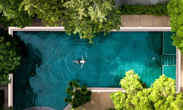 Outdoor saltwater pool at The Park Nine Hotel Srinakarin, surrounded by lush tropical greenery, Bangkok
