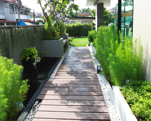 A standard room at The Prima Residence Don Mueang with a wide bed, refrigerator and clean, simple decor