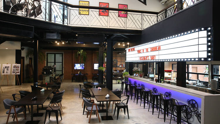 The Box Office Bar lobby at Prince Theatre Heritage Stay with its glowing vintage marquee sign above the bar
