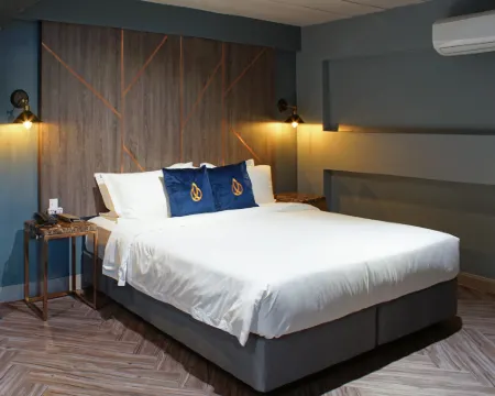 Guest room interior at Ratchada Boutique Hotel with city-view balcony, Bangkok