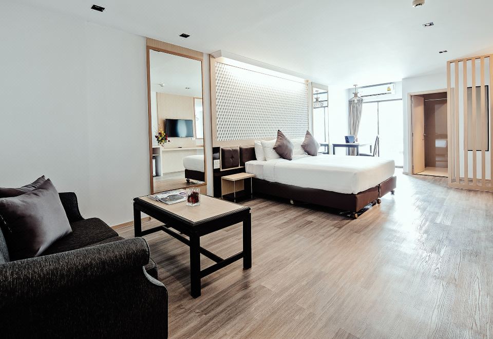 A standard room at Three Sukhumvit Hotel — clean, tidy and furnished in warm wood tones