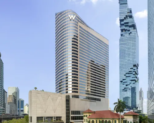 WET Deck outdoor pool at W Bangkok — eye-shaped pool illuminated at night