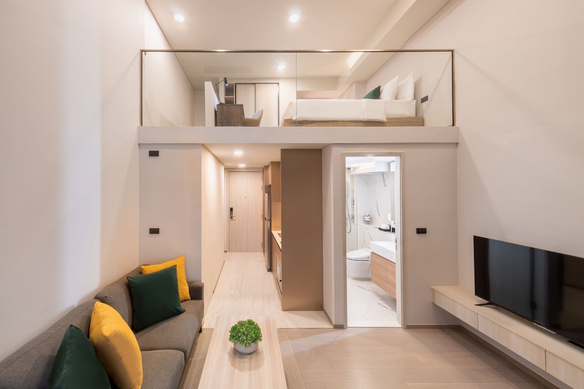 A One Bedroom Duplex Suite King at Wyndham Garden Bangkok Sukhumvit 42 — king bed, kitchenette and city-view balcony