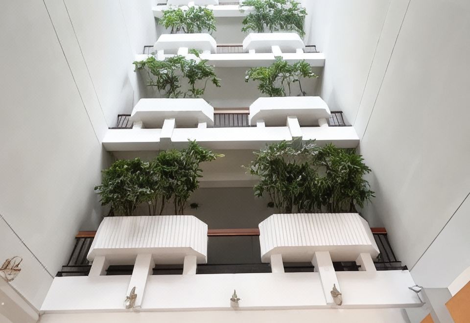 มุมห้องพักของ Lertnimit Hotel ชัยภูมิ พร้อมเตียงและสิ่งอำนวยความสะดวกพื้นฐาน