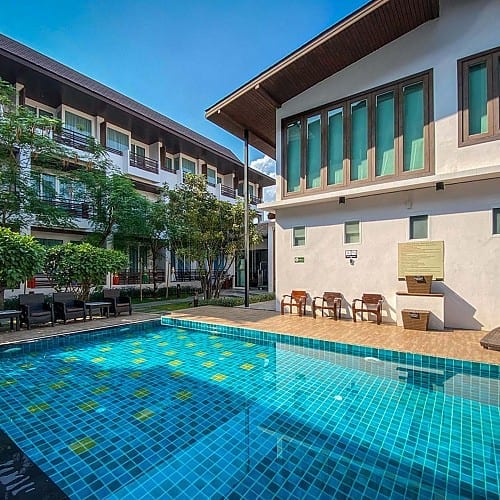 สระว่ายน้ำเกลือกลางแจ้งของ Le Patta Hotel Chiang Rai พร้อมบ่อปลาคาร์ปและสวนเขียวร่มรื่น