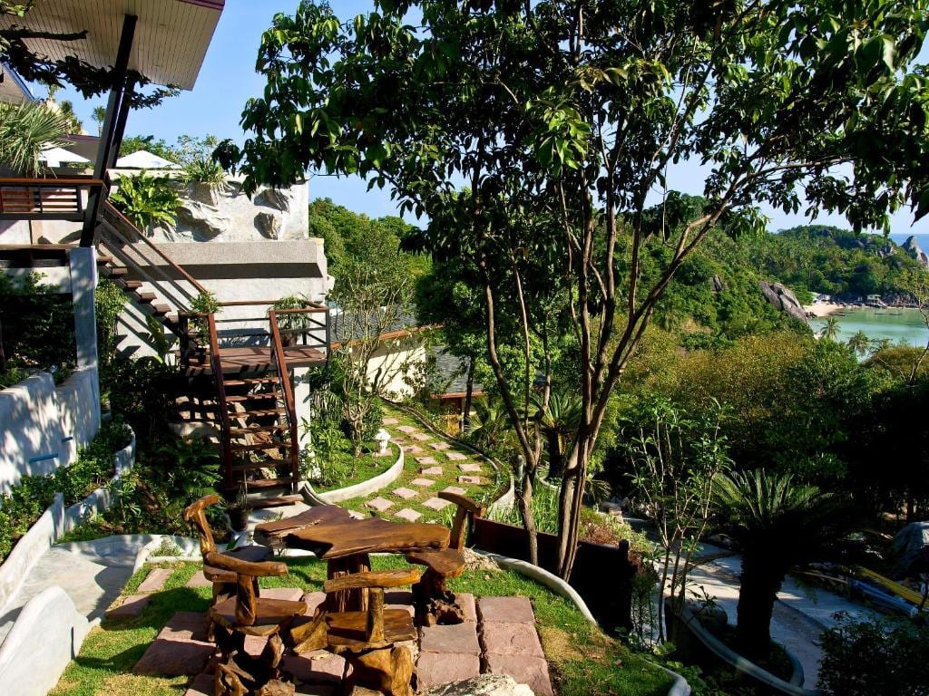 Tropical wooden bungalow with a private sea-view balcony at Chintakiri Resort on the hillside