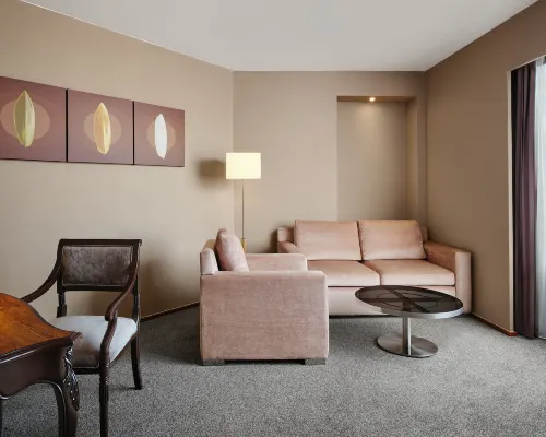 Suite living room at Jubilee Prestige Hotel Ratchadapisek — classic styling with city views