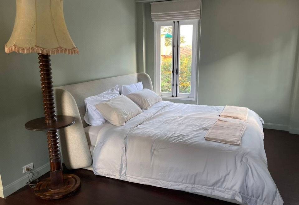 A room at La Casetta decorated in warm tones, with large windows looking out over the garden and mountains