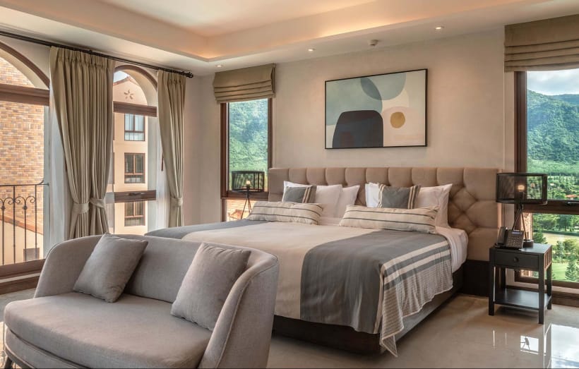 Balcony Suite at Castello Della Valle, warm-toned decor with a balcony and mountain view