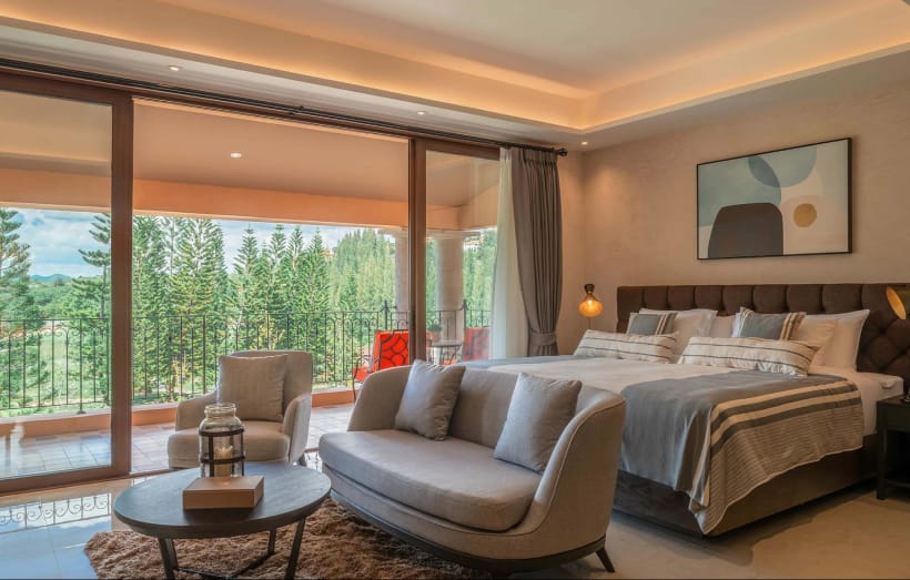 Superior Suite in warm tones with a soft bed and golf-course view