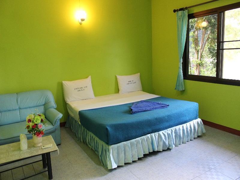 Small wooden bungalows on the hillside at Bang Bao Cliff View Resort