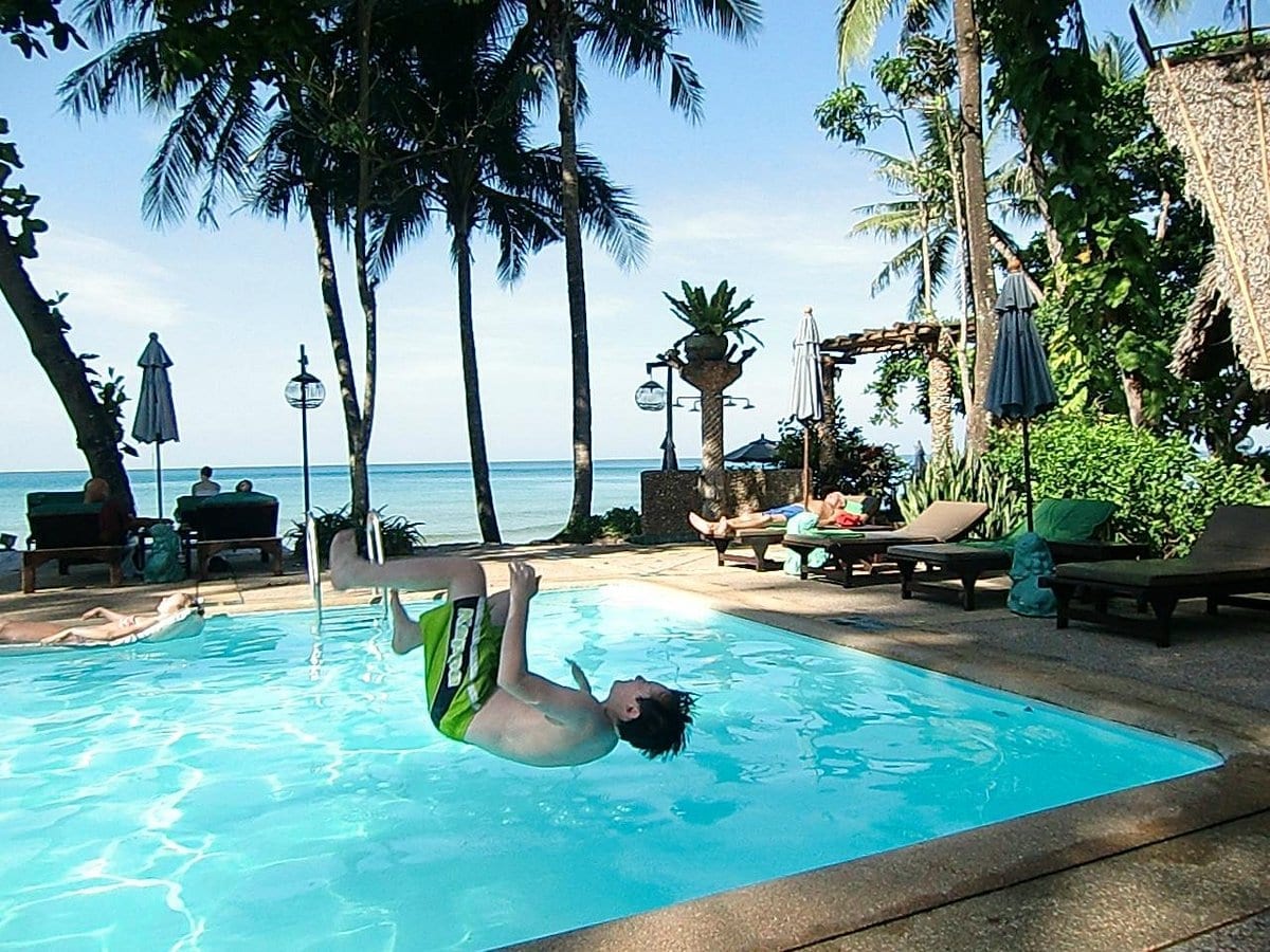 Wooden bungalows and the green beachfront garden at Banpu Koh Chang Resort on White Sand Beach