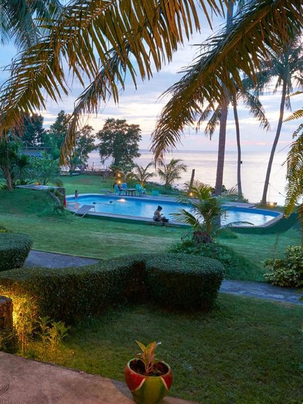 Colourful bungalow at Elephant Bay Resort, Koh Chang, with a private balcony looking onto the green garden