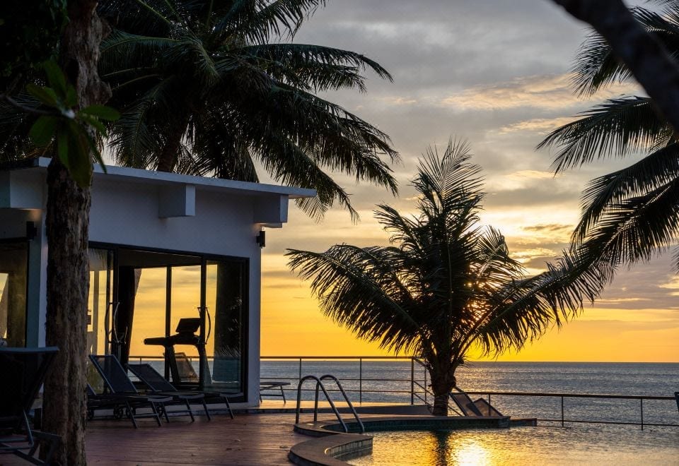 The outdoor pool at Koh Chang Grandview Resort beside White Sand Beach, surrounded by a shady garden and trees