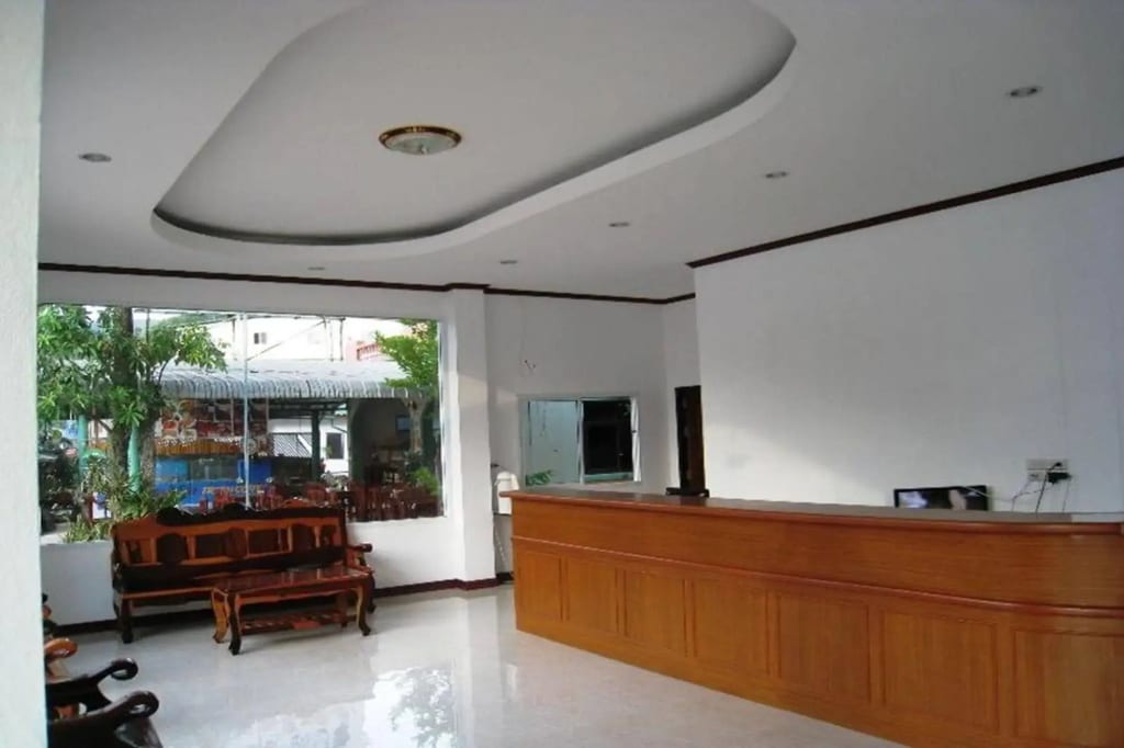 Air-con guest room at Kachapol Hotel, simply furnished and clean, with a balcony