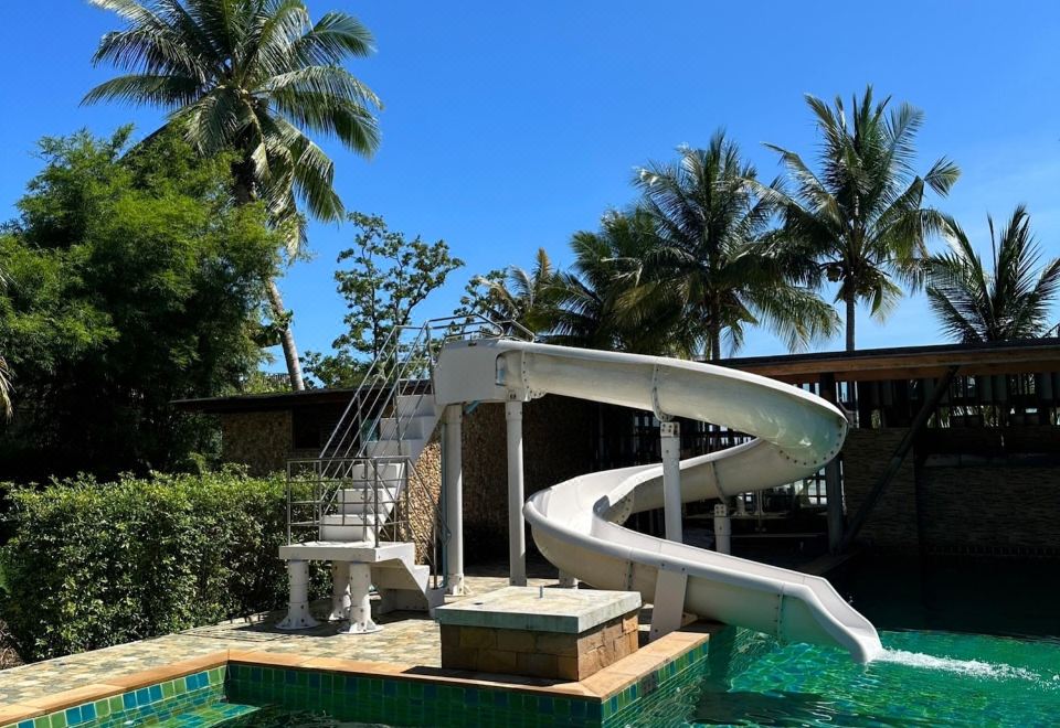 Outdoor pool and sun loungers at the beachfront resort on Kai Bae Beach