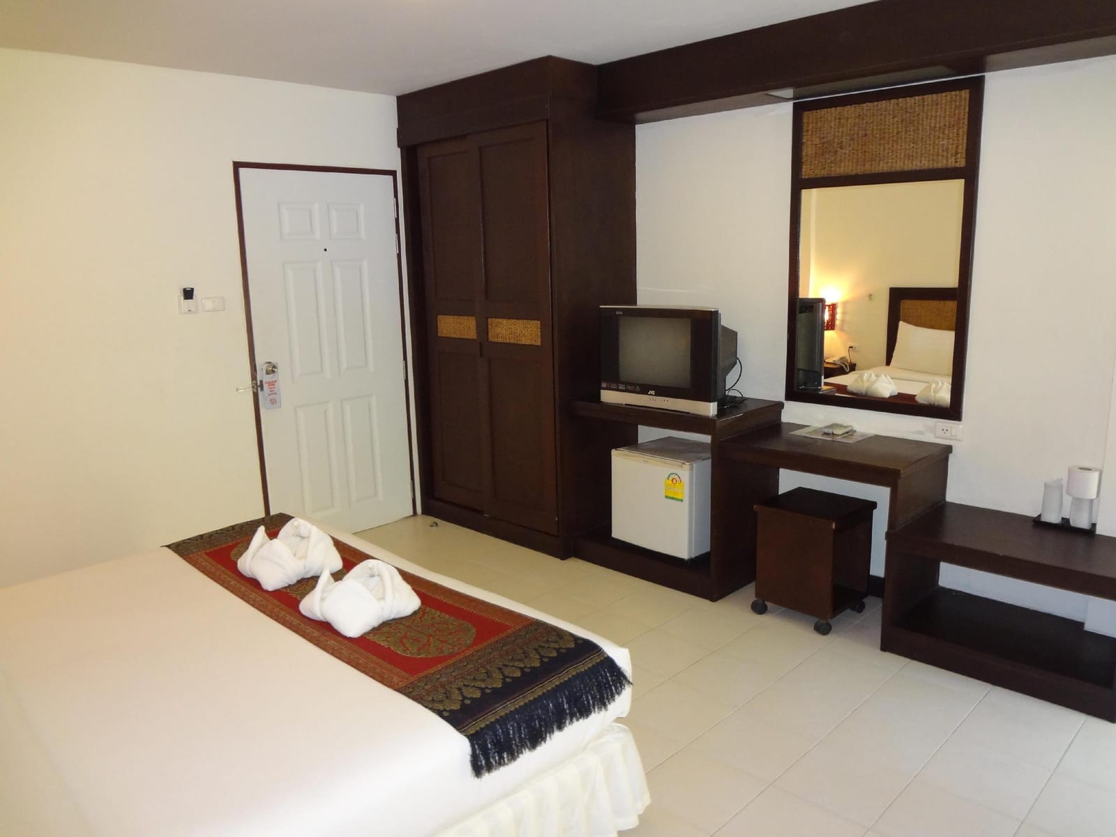 A room at Paddy's Palms Resort, simply furnished in warm tones with air conditioning