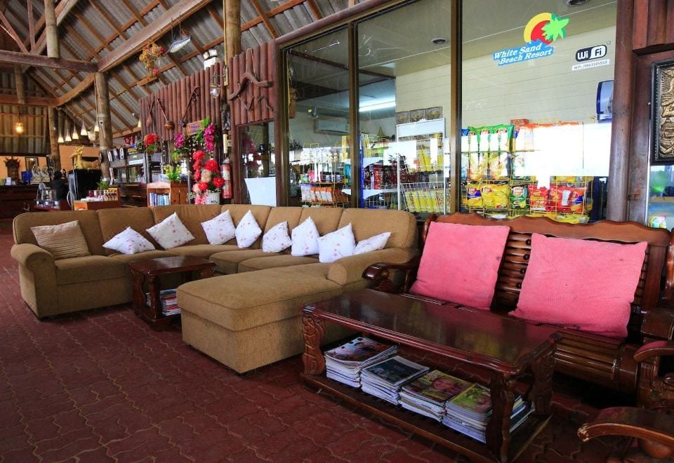 Lobby and reception area of White Sand Beach Resort, a wooden structure with a small convenience corner