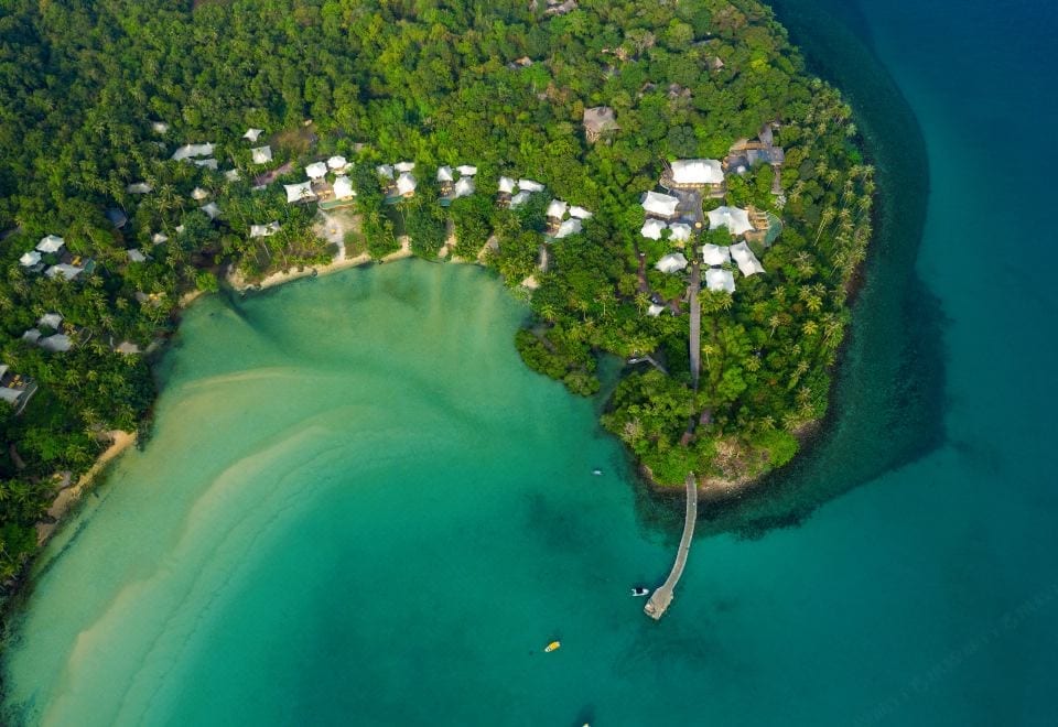 The barefoot-luxury feel of Soneva Kiri, with timber architecture and natural materials