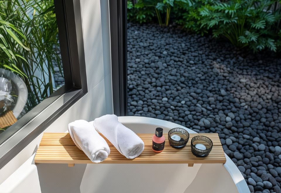 Bright glass-and-concrete villa interior at Rhy.a Private Pool Villa, Tawaen Beach