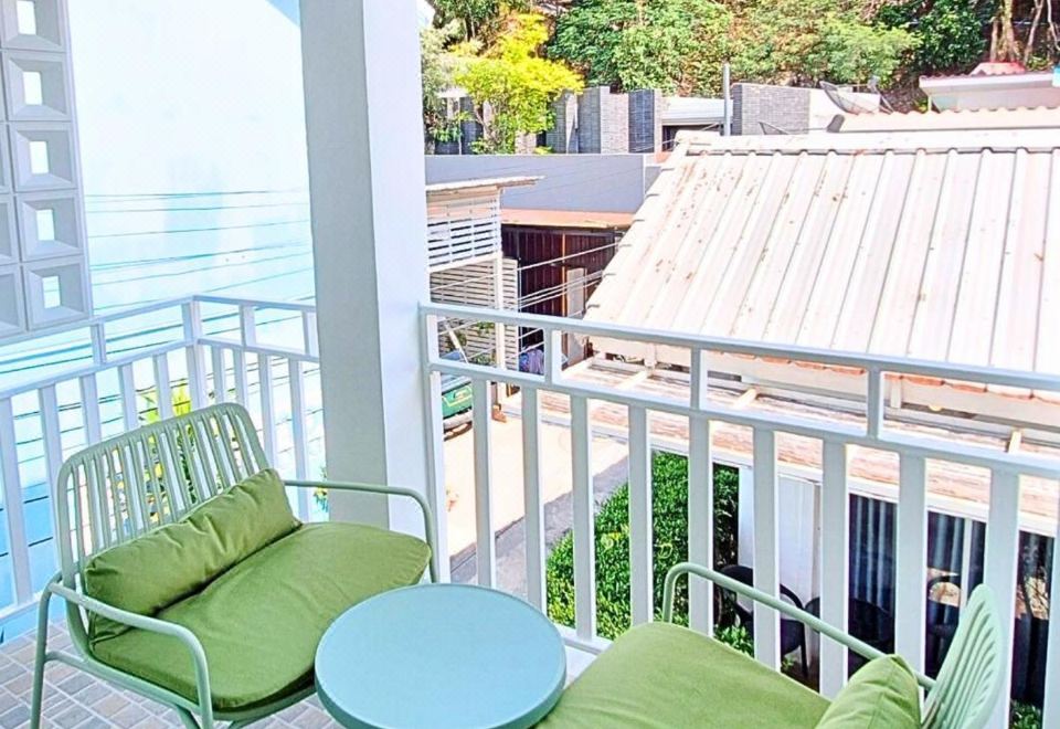Bright, clean guest room at Koh Larn White House with bed and in-room fridge