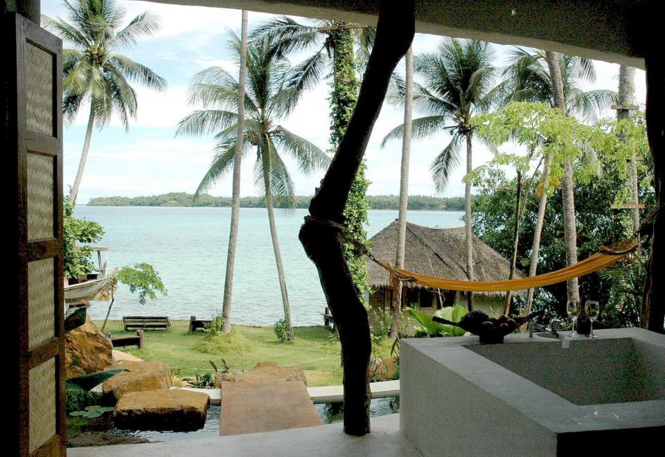 The two-tier outdoor swimming pool at Koh Mak Cococape Resort looking out to sea