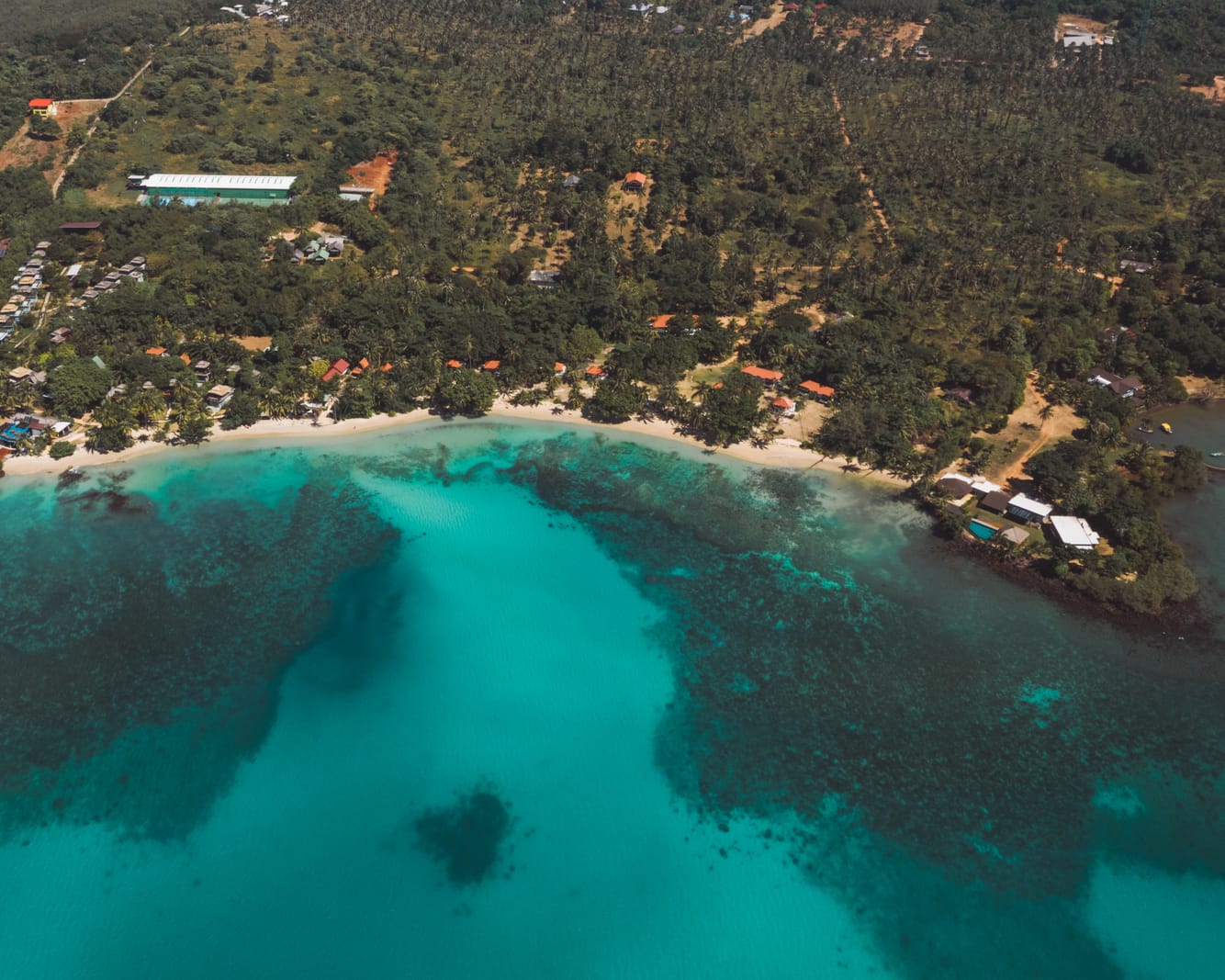 White bungalows of Lazy Day The Resort lined along Ao Kao Beach with sea views