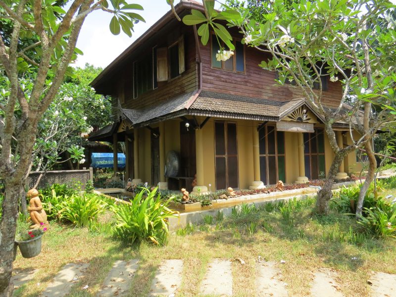 Wood-and-bamboo bungalows in the tropical garden at Monkey Island Resort, Koh Mak
