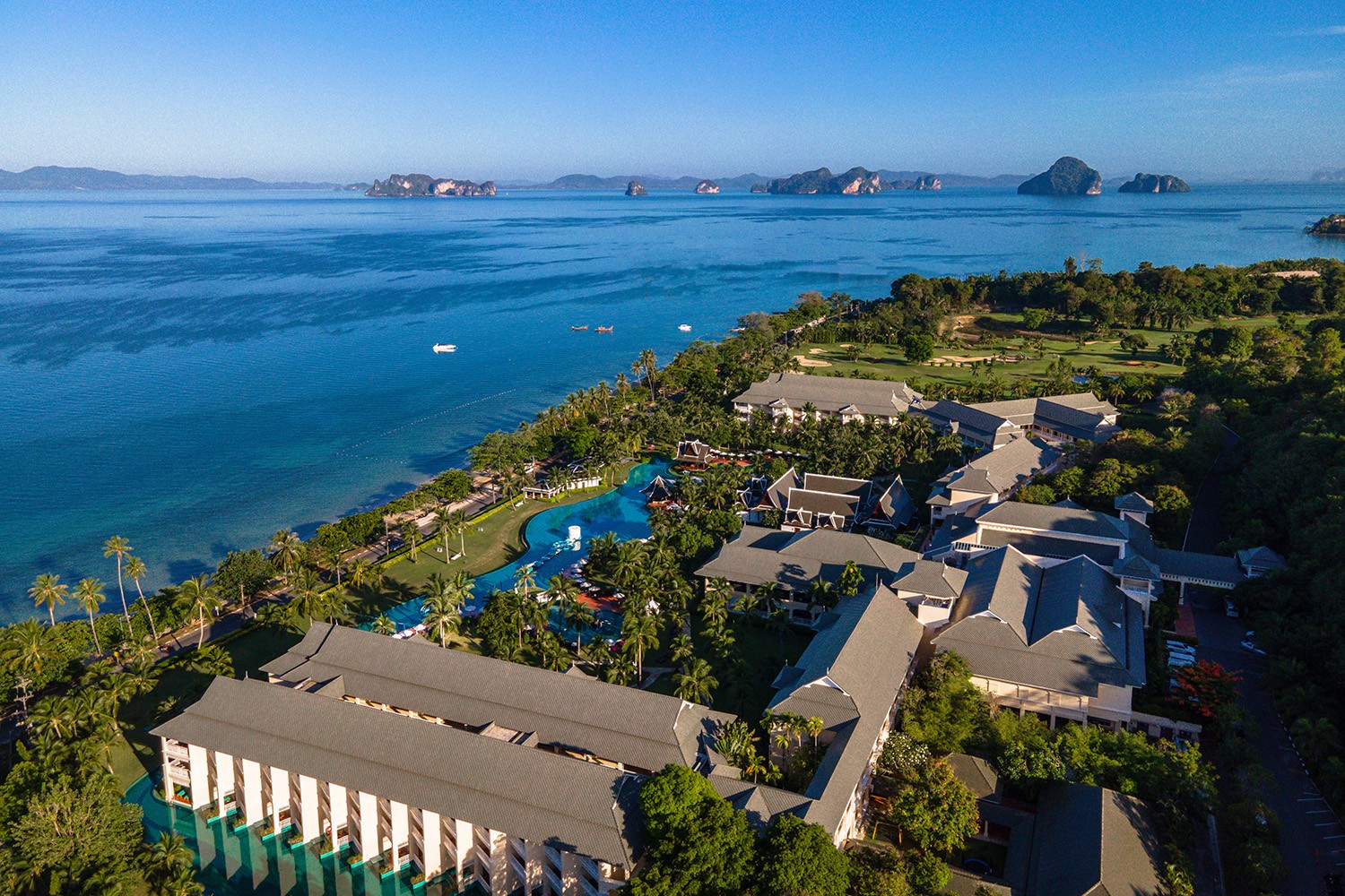 Aerial view of Sofitel Krabi Phokeethra showing the large lagoon pool on Klong Muang Beach with Andaman karst islands beyond