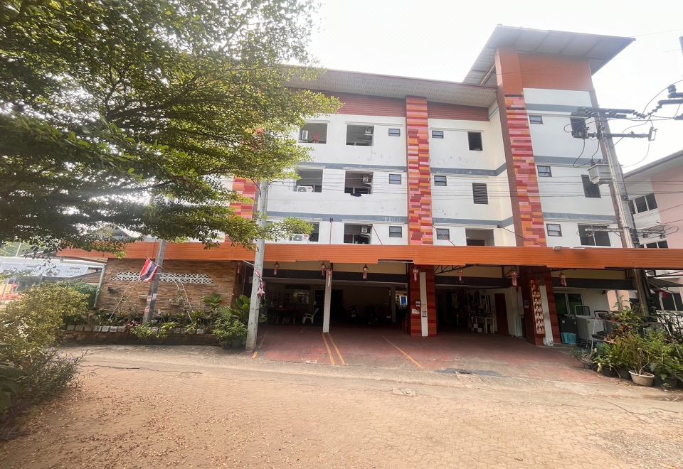 ห้องพักของ The First Residence Lamphun ตกแต่งเรียบ มีเตียงใหญ่และระเบียง