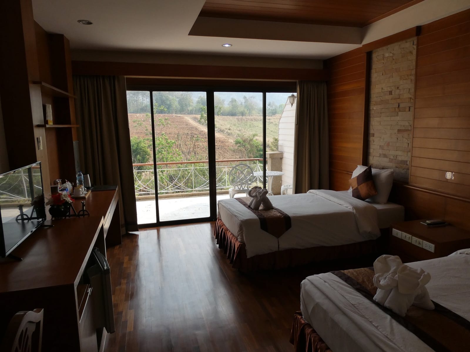 ระเบียงห้องอาหารของ Phurua Resort มองลงไปเห็นน้ำตกเล็กและหุบเขาเขียว