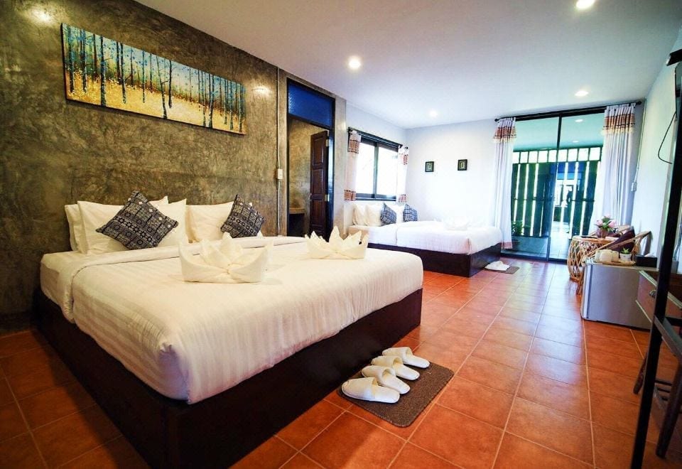 ห้องพักโทนอบอุ่นสะอาดตาของ Pround Nan Cottage น่าน พร้อมเตียงและมุมนั่งเล่น