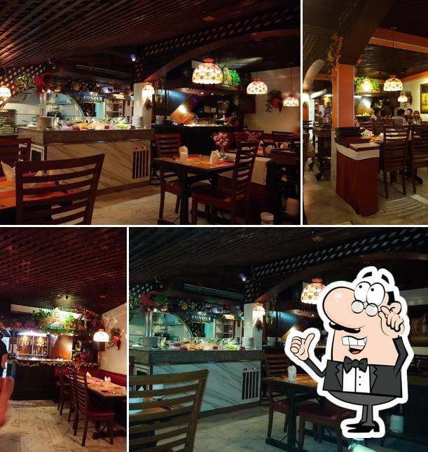 บรรยากาศภายในร้านอาหารสวิสด้านล่างของ Swiss Food Restaurant and Hotel ในซอยไดมอนด์