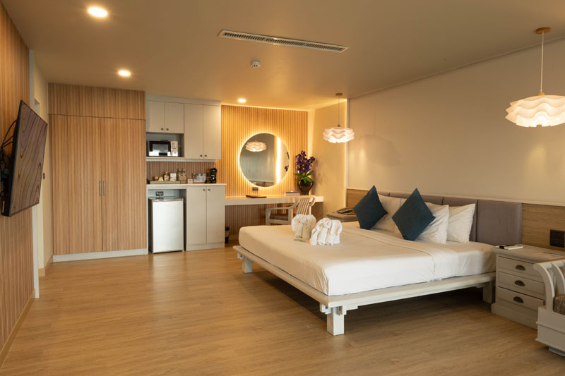 ห้อง Villa Sea View ของ Andaman Cannacia เตียงคิงและหน้าต่างบานใหญ่มองเห็นทะเลอันดามัน