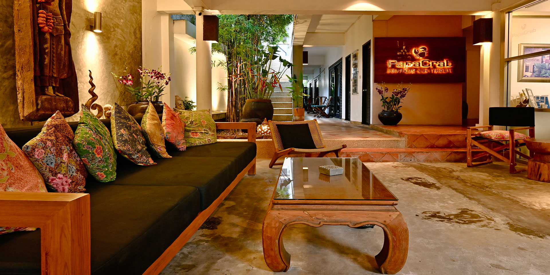 The lobby of PapaCrab Boutique Guesthouse at night, with a warm homely atmosphere