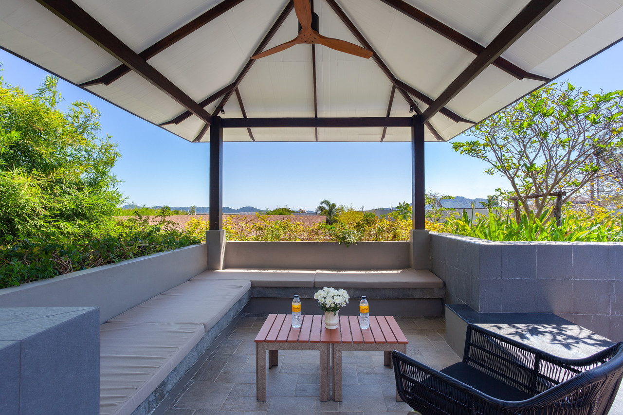 A shaded terrace sala with a sofa and mountain views at STAY Wellbeing & Lifestyle Resort, Rawai, Phuket