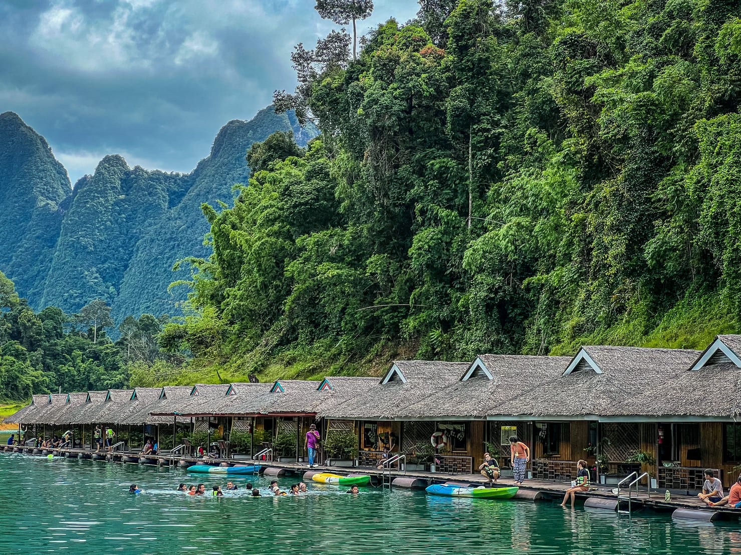 Bamboo floating rafts of Praiwan Raft House in the middle of Cheow Lan Lake surrounded by limestone mountains