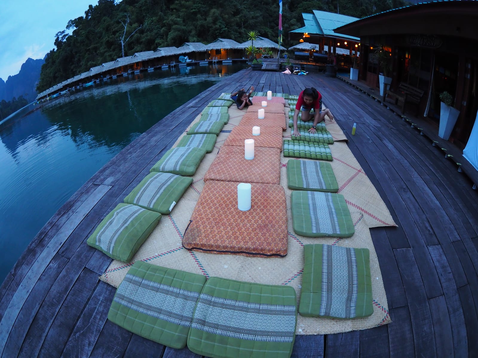 Freshly cooked Southern Thai meal served on a Praiwan Raft House raft with emerald water and limestone cliffs behind