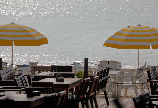 ร้านอาหารริมทะเลของ Tubtim Resort วางโต๊ะบนหาดทรายมองวิวอ่าวทับทิม