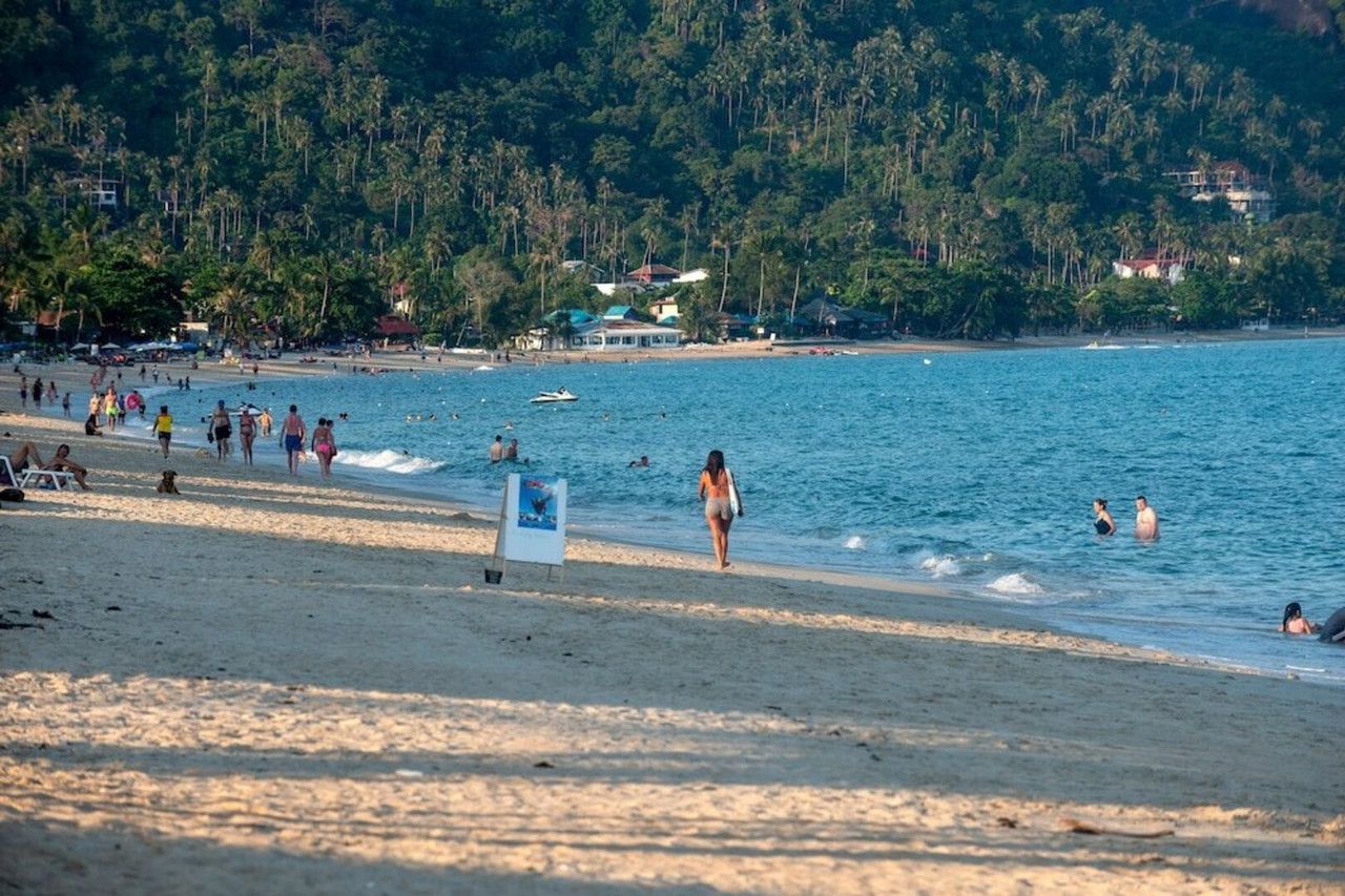 หาดละไมทรายกว้างและทะเลอ่าวไทยหน้า Aloha Resort เกาะสมุย มีคนเดินเล่นและลงเล่นน้ำ