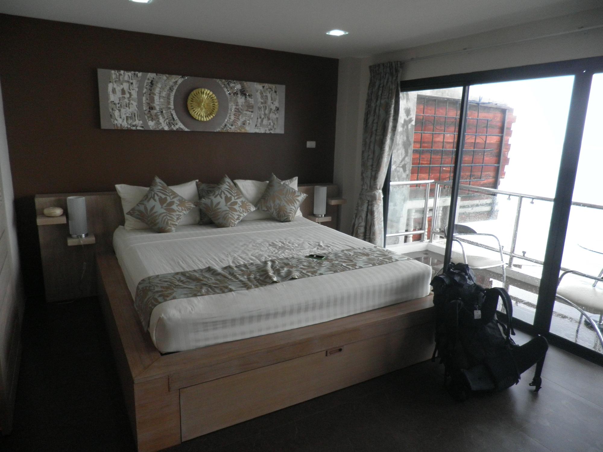 A Hacienda suite: a King bed with glass doors onto a private sea-view balcony