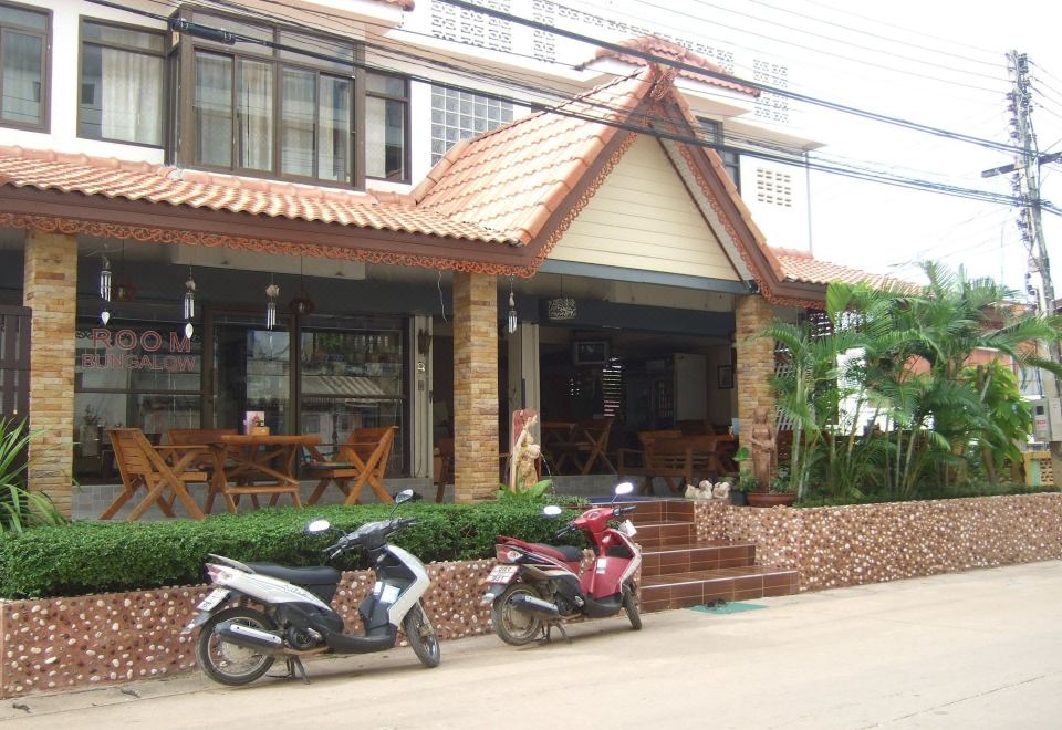 บังกะโลในสวนของ At Home Sukhothai พร้อมระเบียงเล็กๆ มองออกไปเห็นสวนและสระบัว