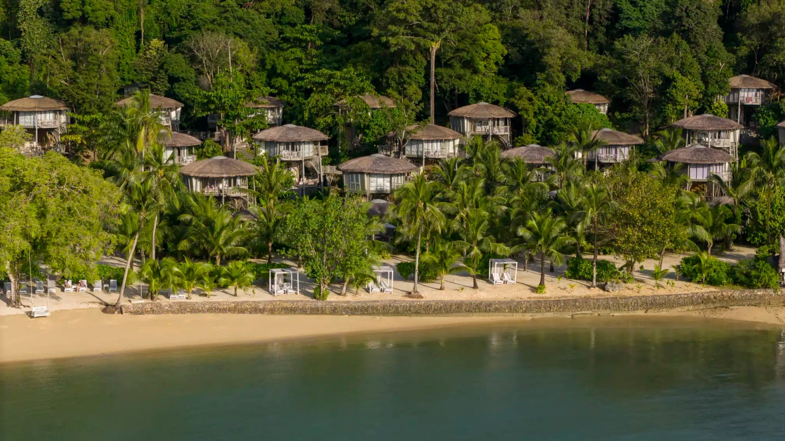 The private beach at TreeHouse Villas Koh Yao facing Phang Nga Bay, ringed by limestone cliffs